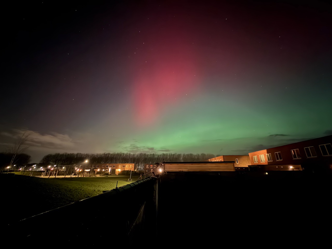Northern lights visible above the Dutch countryside near Almere.